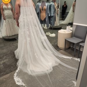 Brand new wedding dress tags still on. With veil.